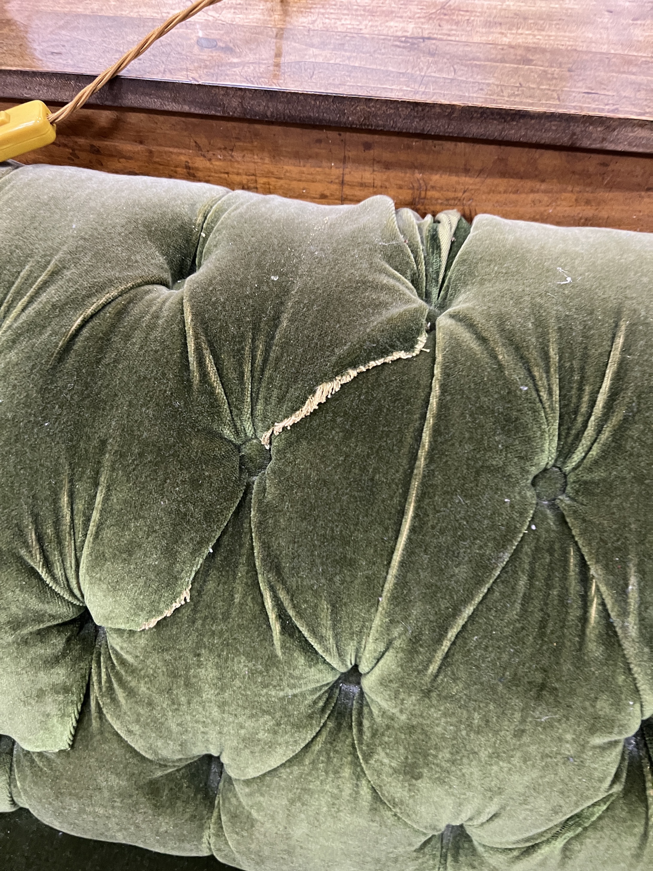 A late Victorian Chesterfield settee upholstered in buttoned green fabric, length 180cm, width 90cm, height 72cm
